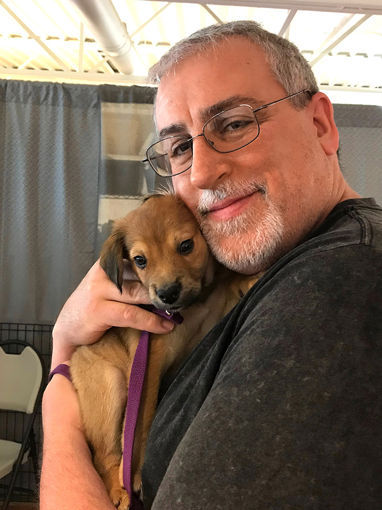 Brian Garrison holding a puppy